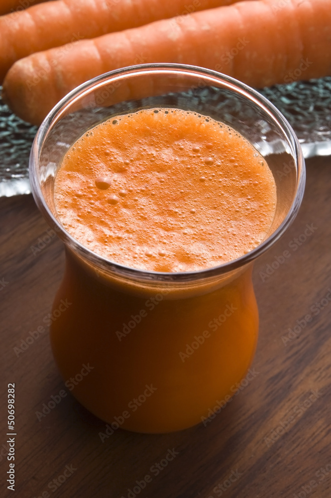 carrot juice on a wooden background carrot juice on a wooden background