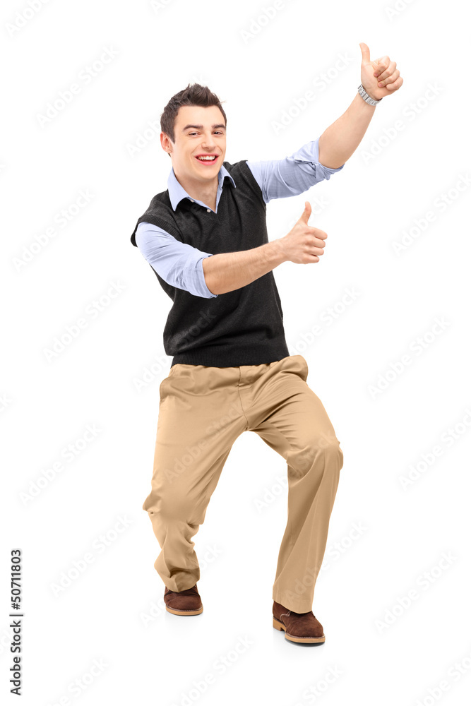 Full length portrait of a young cheerful man gesturing happiness Full length portrait of a young cheerful man gesturing happiness