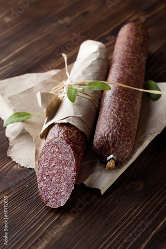 Salami on wooden and paper