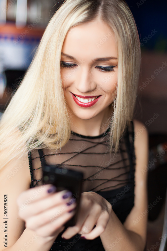 Beautiful young business woman smiling with mobile phone in cafe Beautiful young business woman smiling with mobile phone in cafe