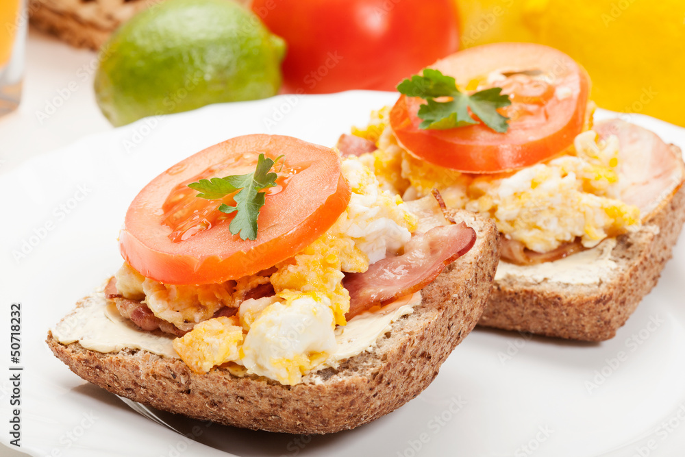 Sandwich with scrambled eggs and bacon. Selective focus.