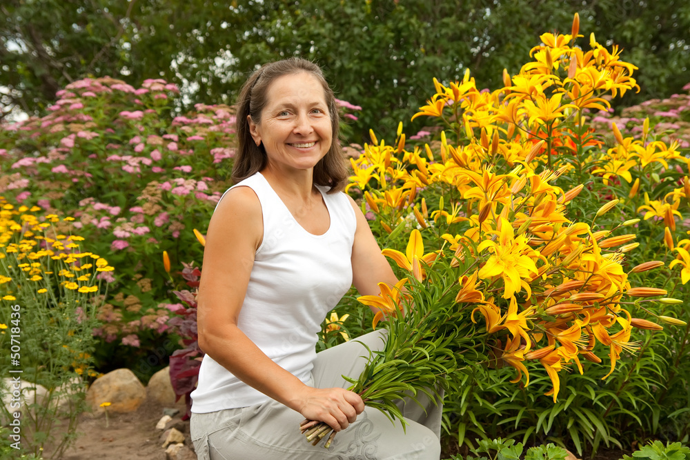 gardener in flower bed with bouguet gardener in flower bed with bouguet