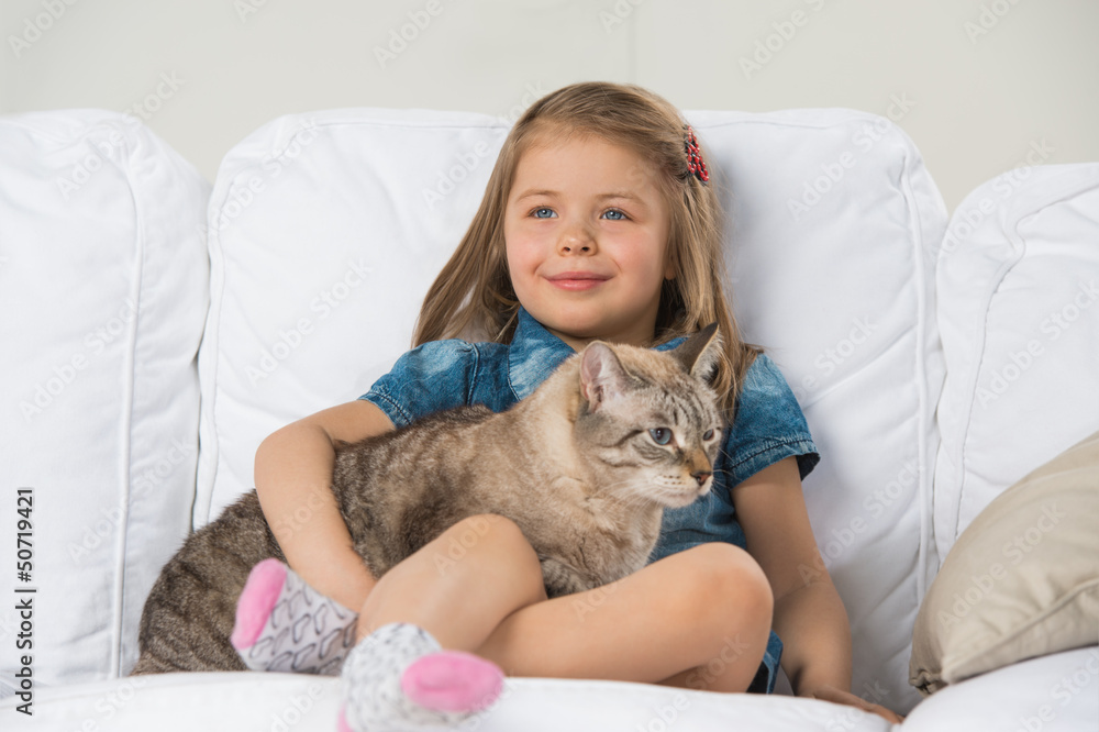 Cute little girl hugging tabby cat with love, looking away. Cute little girl hugging tabby cat with love, looking away.