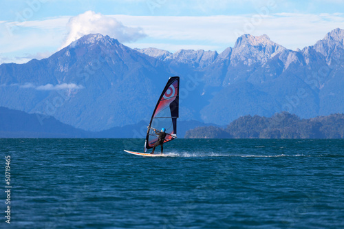 Windsurfer on mountain lake
