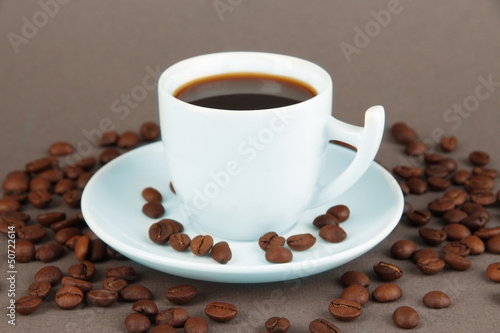 Cup of strong coffee on grey background