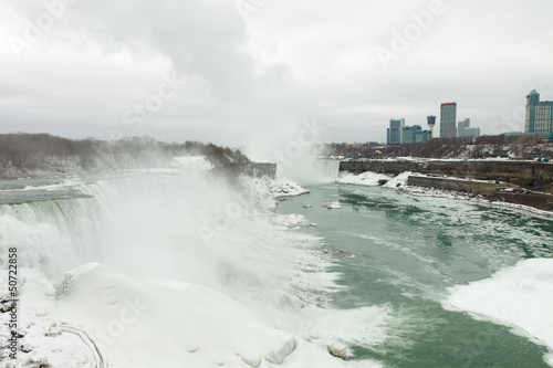 Black and white DSLR image of Niagara Falls in winter; horizontal with copy space for text