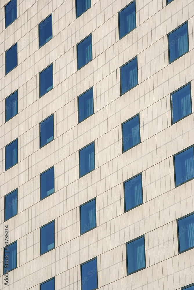 Modern public building wall,  blue windows as background