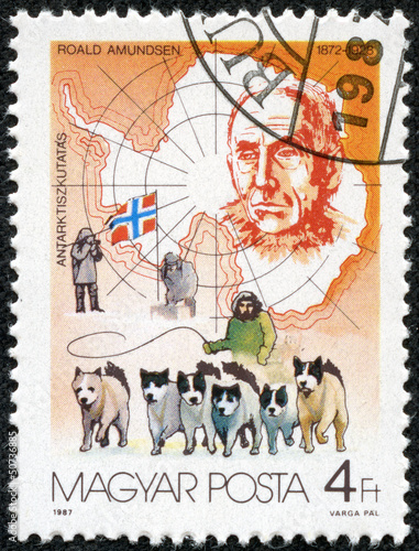 stamp shows Roald Amundsen  discovering South Pole, dog team photo