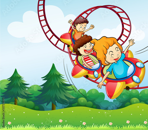 Three kids riding in the roller coaster