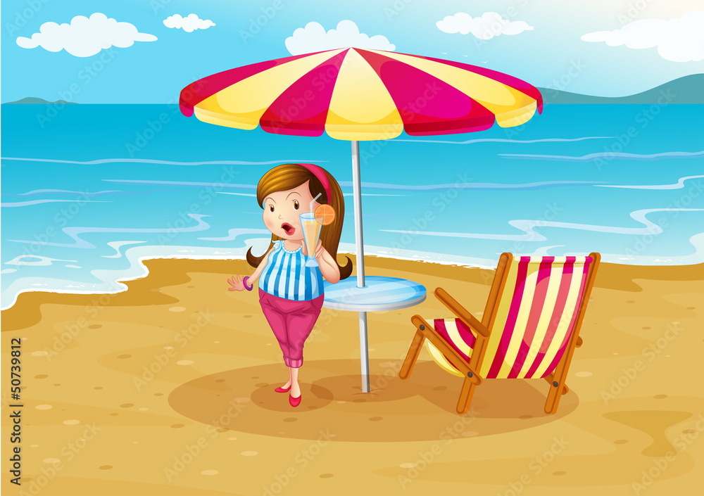 A girl at the beach with an orange juice A girl at the beach with an orange juice
