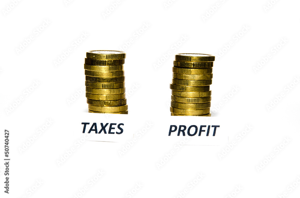 Taxes and profit signs at coin piles Taxes and profit signs at coin piles