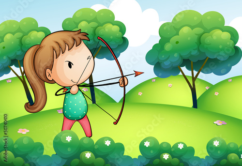A girl holding a bow and arrow in the hills