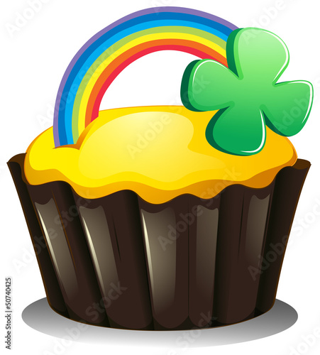 A cupcake with a rainbow and a plant