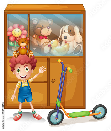A boy and his scooter in front of his toy collections
