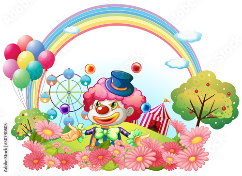 A clown in the garden with a carnival at the back