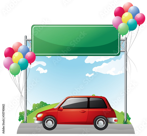 A tinted red car near the empty green board