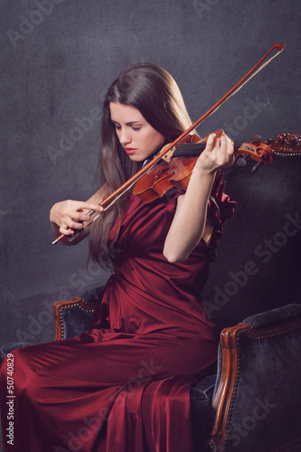 Canvas Print Beautiful girl playing a fiddle with eyes closed