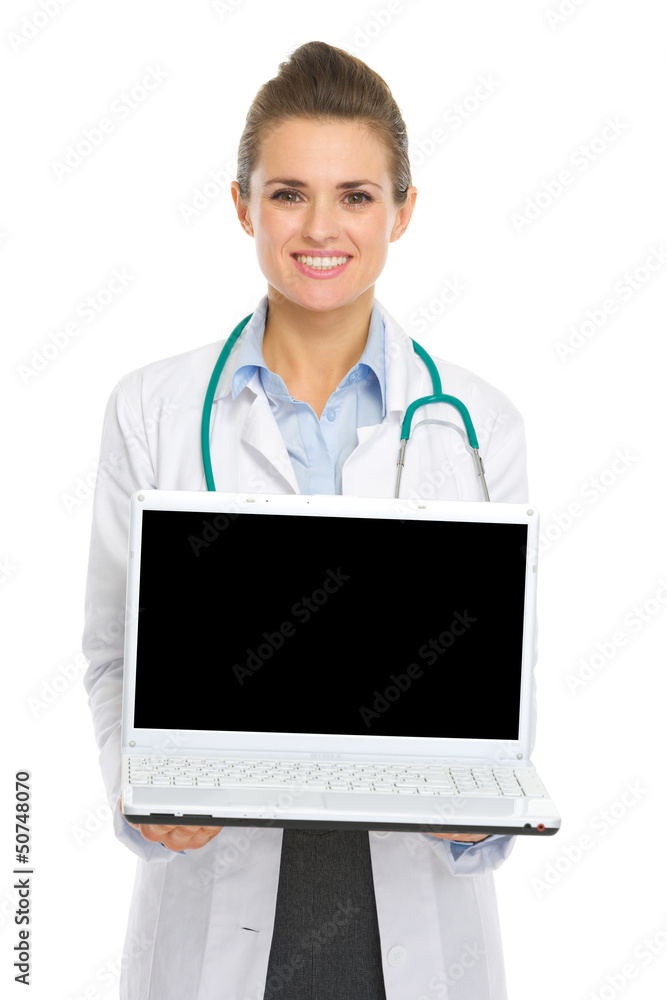 Smiling medical doctor woman showing laptop Smiling medical doctor woman showing laptop