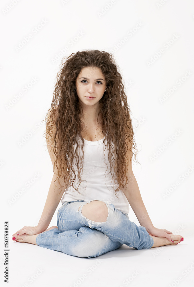 Sexy girl with long curly hair in white shirt and torn jeans Stock Photo |  Adobe Stock