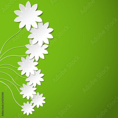 White paper flowers on green background
