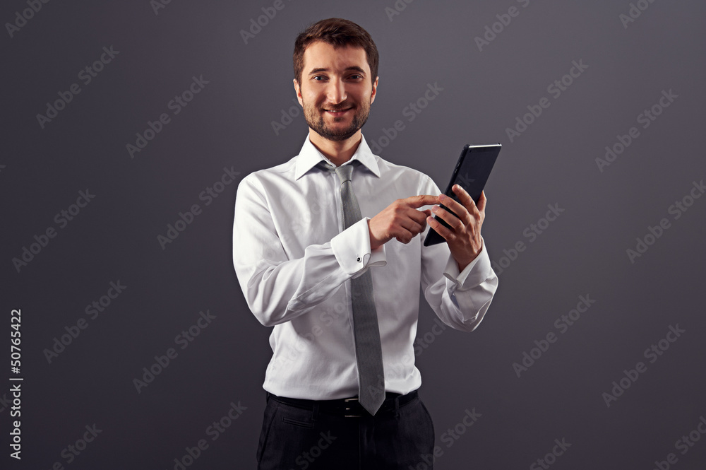 smiley businessman pointing at tablet pc smiley businessman pointing at tablet pc