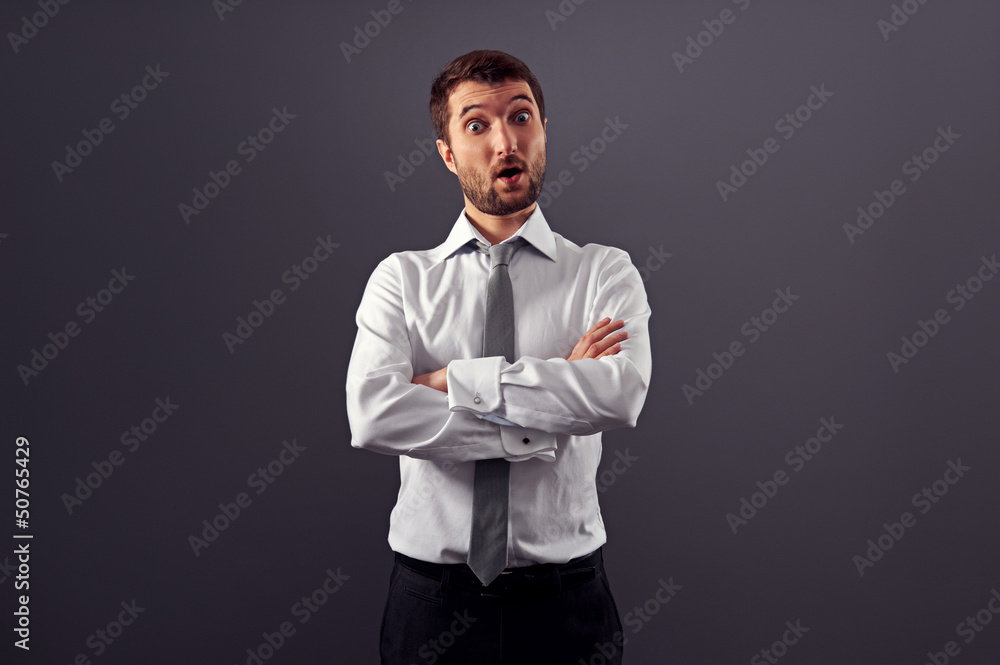 surprised businessman over grey background surprised businessman over grey background