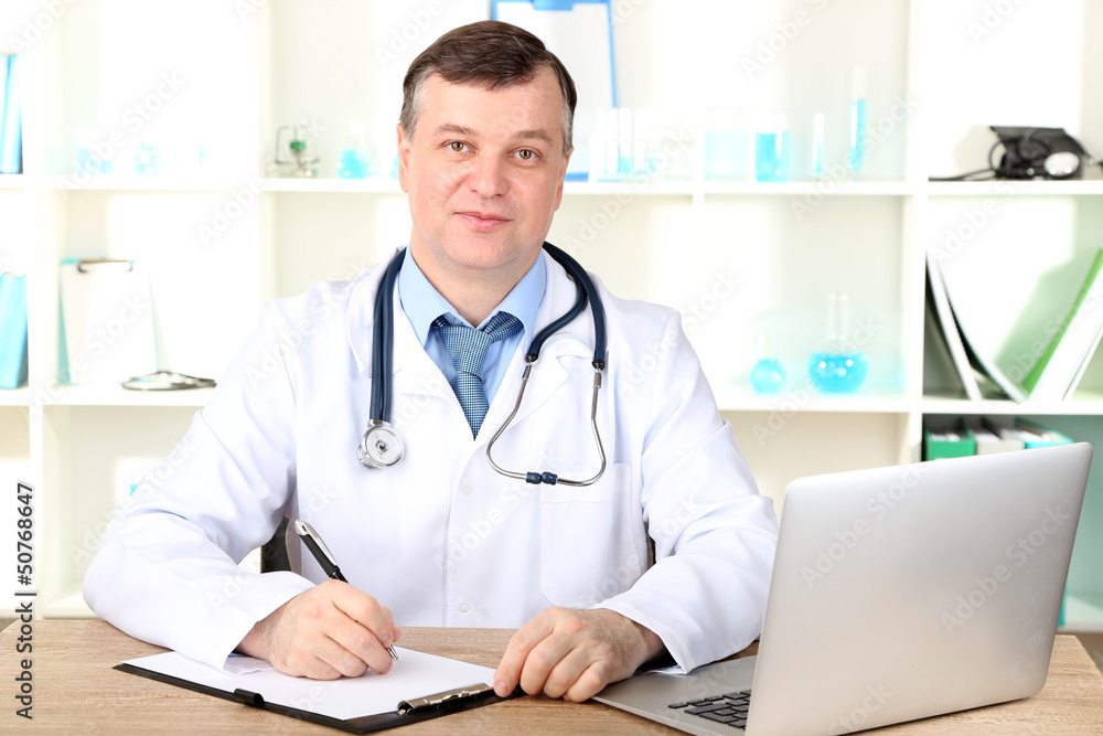 Medical doctor working at desk Medical doctor working at desk