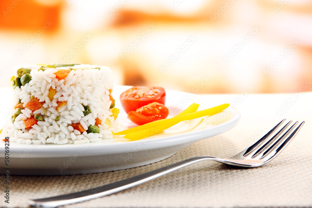 Delicious risotto with vegetables on table in cafe Delicious risotto with vegetables on table in cafe