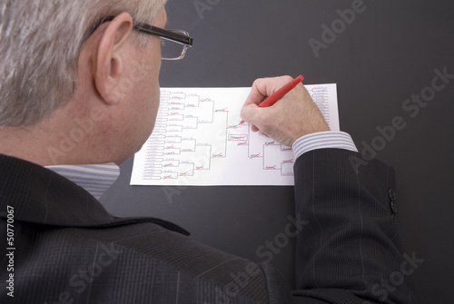 Slika na platnu March Madness Businessman Crossing Out Teams on Bracket