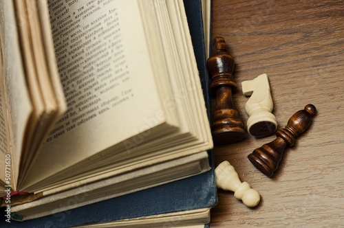 old book and wooden chess