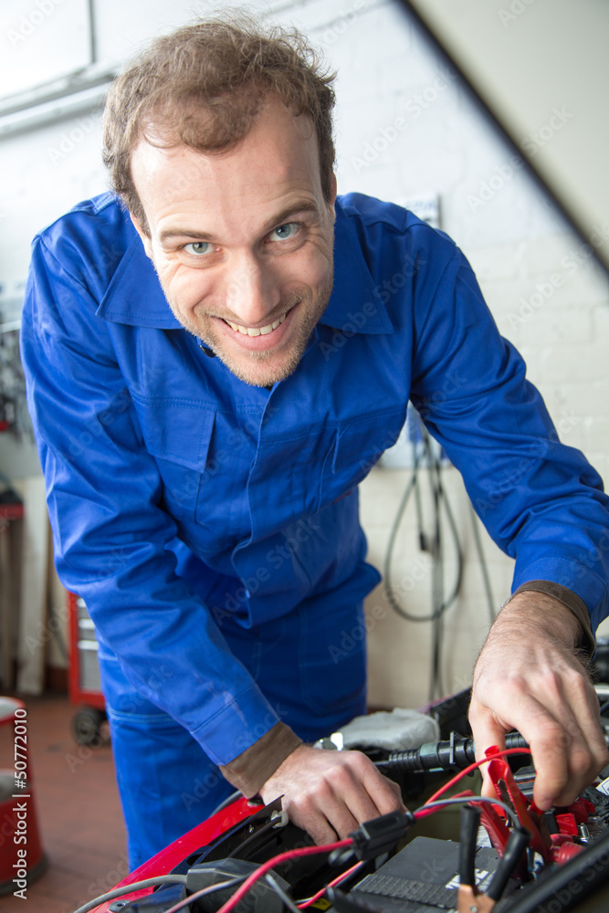 Car mechanic repairing a automobile Car mechanic repairing a automobile