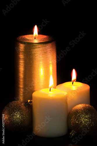 Golden Christmas Candle on the black