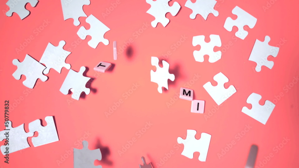 Letters bouncing and spelling out autism next to jigsaw puzzle Letters bouncing and spelling out autism next to jigsaw puzzle