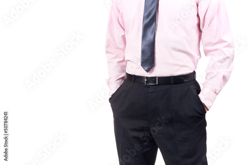 Well dressed man standing with his hands in the pockets isolated