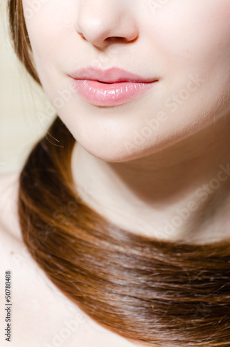 Closeup portrait of a beautiful girl face. Perfect skin & hair.