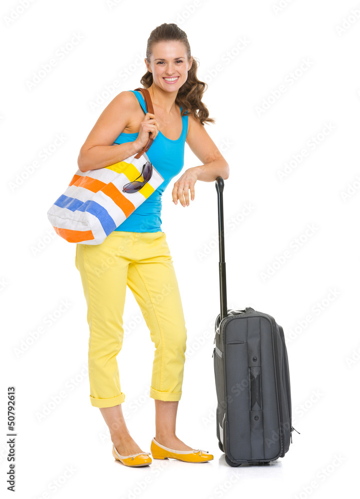 Smiling young tourist woman with wheel bag Smiling young tourist woman with wheel bag