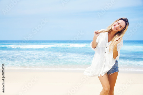 woman in white clothing refreshing at the ocean, bali