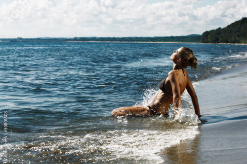Young woman splashing in sea