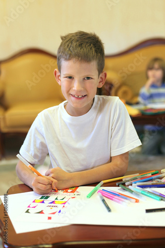 A boy with colored felt pens