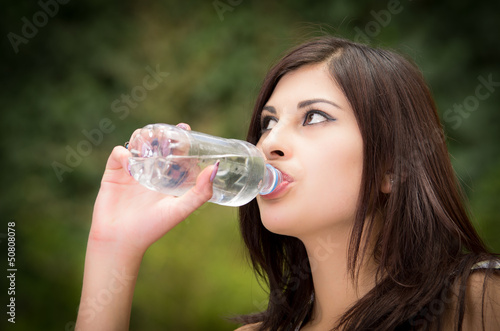 Portrait of woman drinking water outdoor