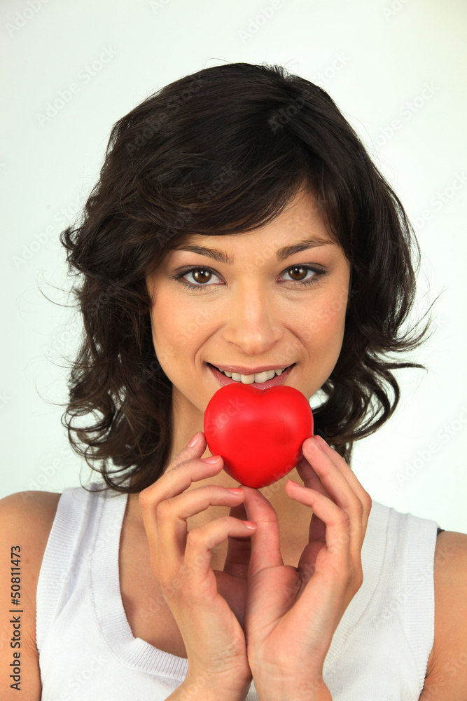 Young woman with red heart in hand Young woman with red heart in hand