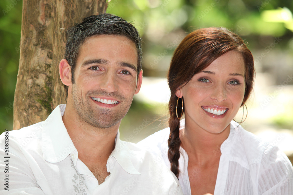 Couple in front of a tree trunk