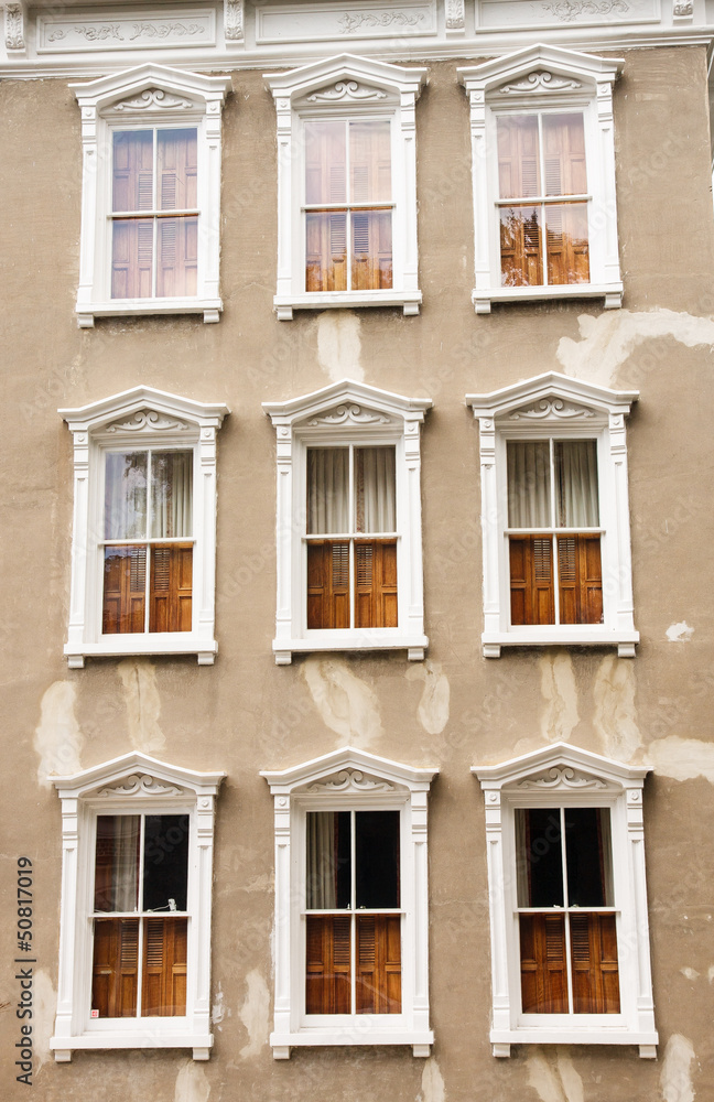 Obraz premium White Windows on Patched Plaster Wall