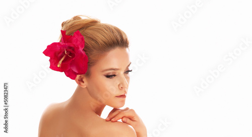 Portrait of beautiful spa woman face with red flower in hair, lo