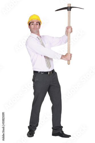full-body portrait of architect holding pickaxe © auremar