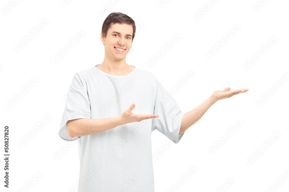 A smiling male patient showing towards something with his hands A smiling male patient showing towards something with his hands