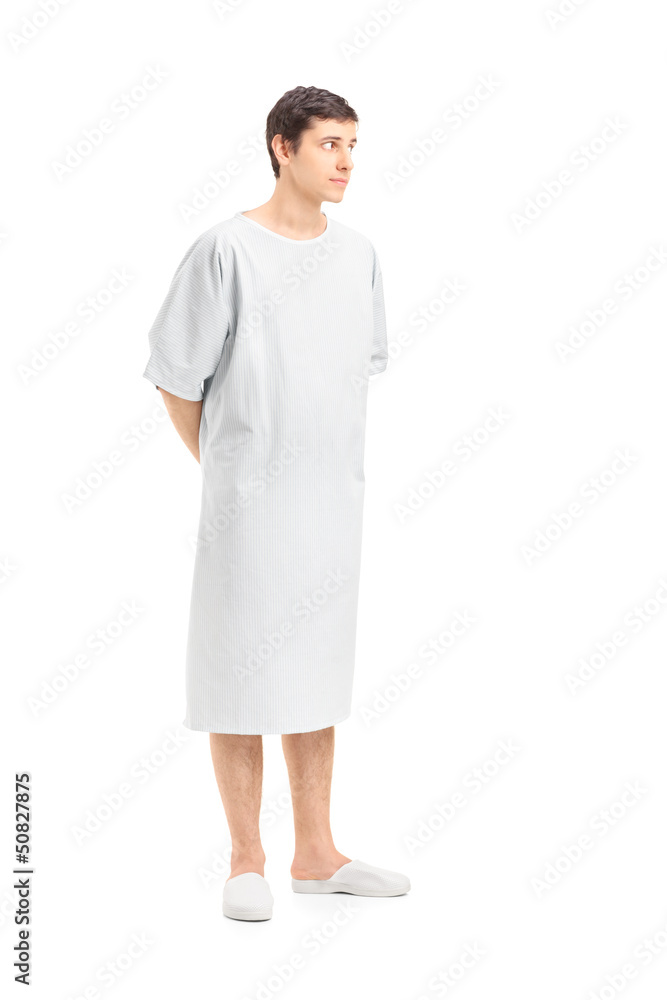 Full length portrait of a male patient in a hospital gown lookin Full length portrait of a male patient in a hospital gown lookin