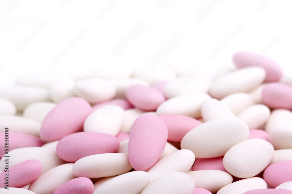 heap of white and pink sugared almonds heap of white and pink sugared almonds