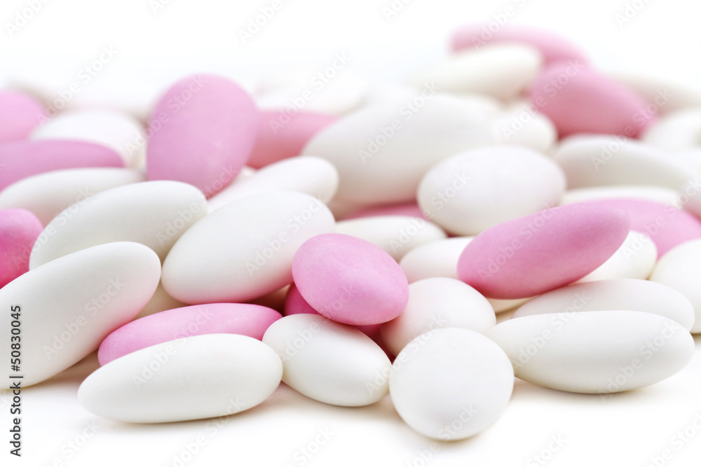 heap of white and pink sugared almonds heap of white and pink sugared almonds