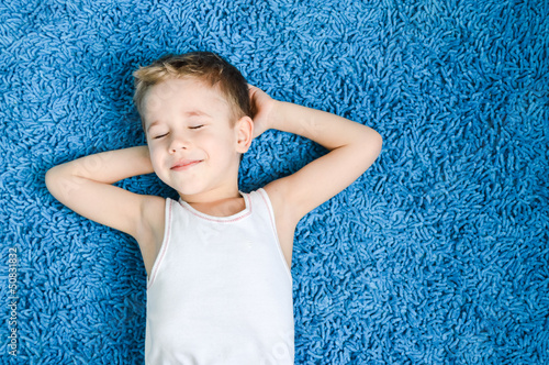 Happy kid on floor in living room at home